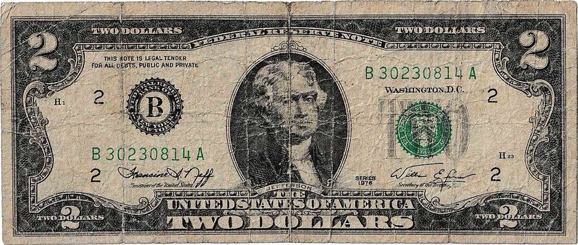 Front of a worn Series 1976 two-dollar bill with Thomas Jefferson